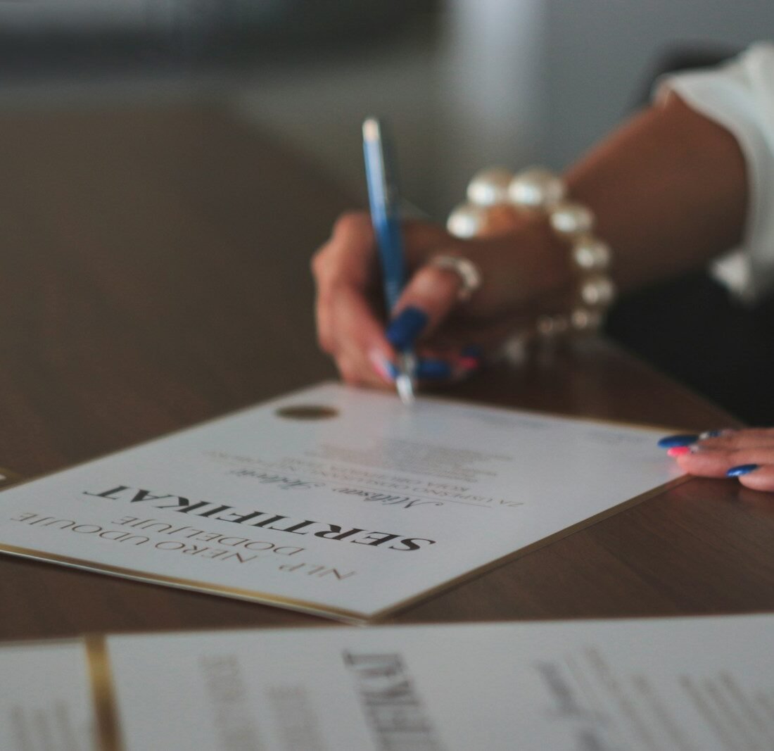 a woman writing on a piece of paper